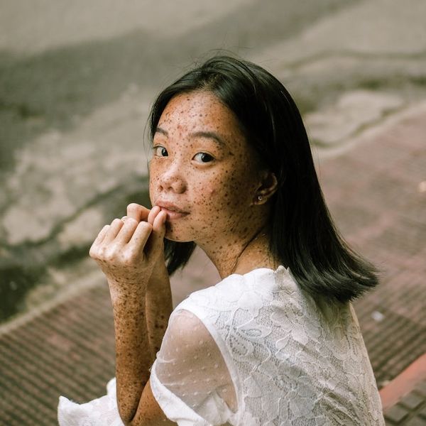 Person sitting in a lotus pose with a serene expression.